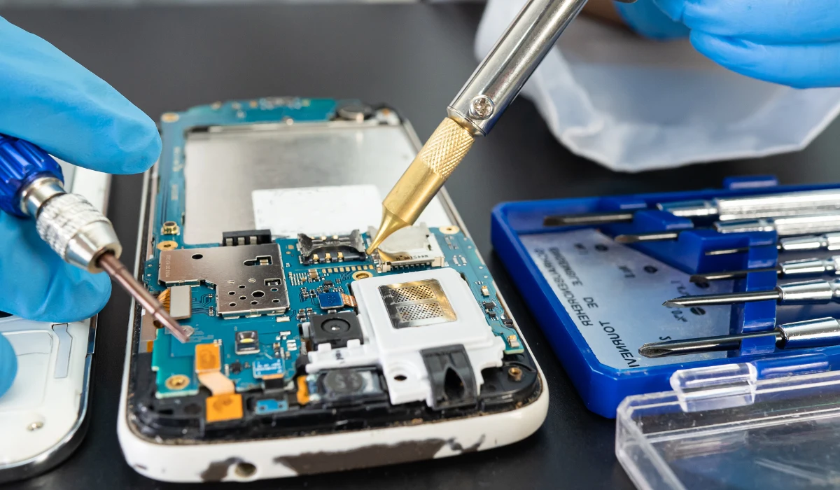 Technician inspecting a laptop in a workshop, illustrating the refurbishment process